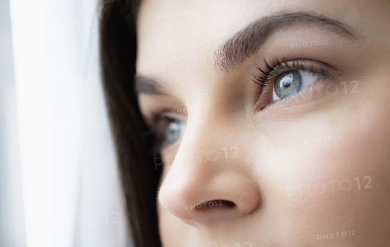 Close up of young woman with blue eyes.