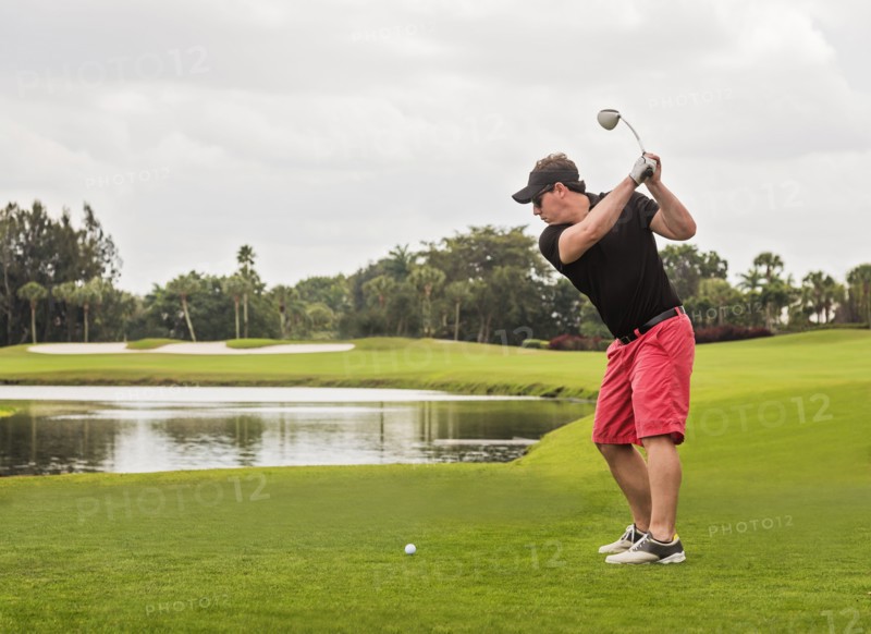 Mid adult man playing golf