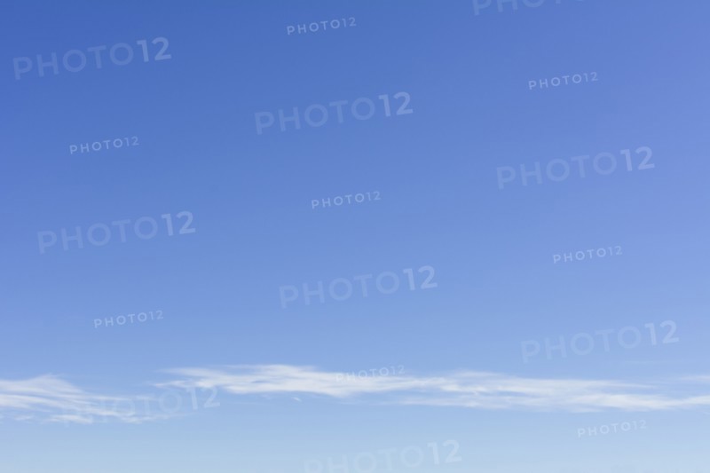 Clear blue sky with scattered clouds