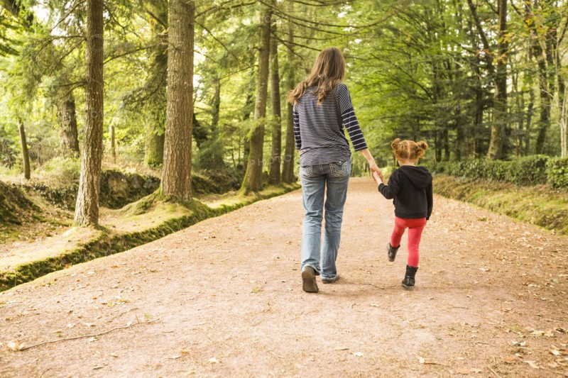 Mother walking with daughter (4-5) in park