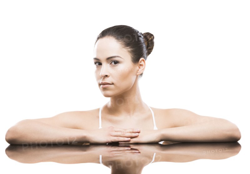 Portrait of woman leaning on mirror