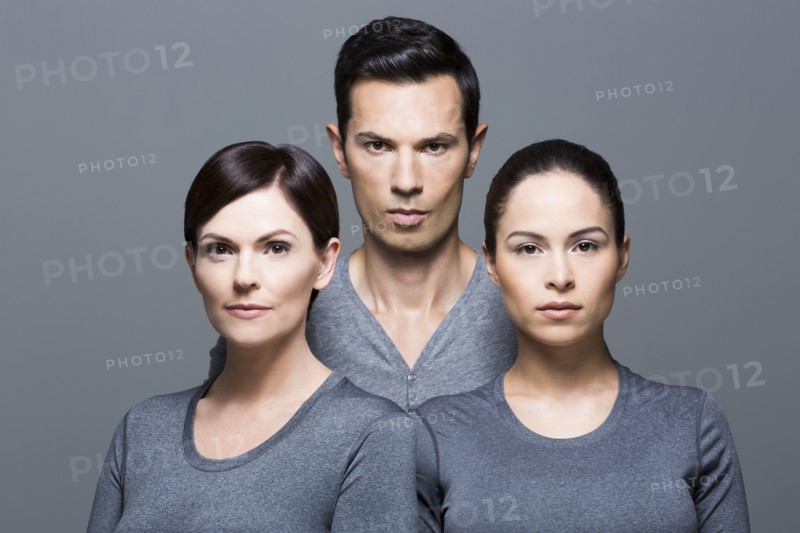 Man and two women wearing grey tops