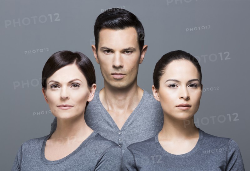 Man and two women wearing grey tops