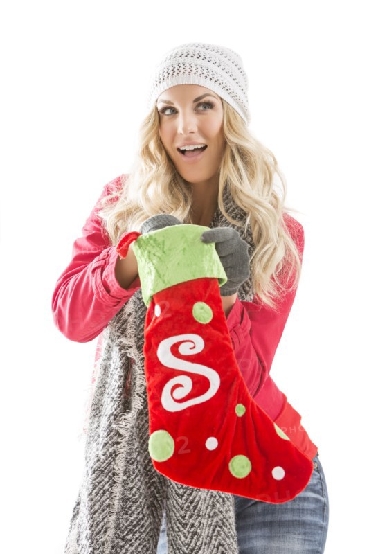 Portrait of young woman holding Christmas stocking