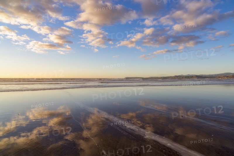 Cloudy sky reflected in sea