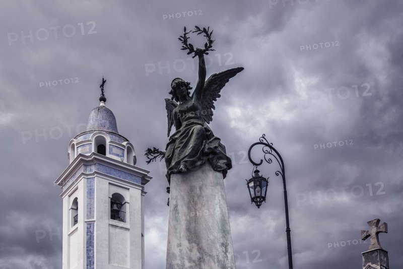 Statue and bell tower of Our Lady Del Pilar Church