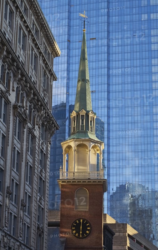 Clock tower against skyscraper in background