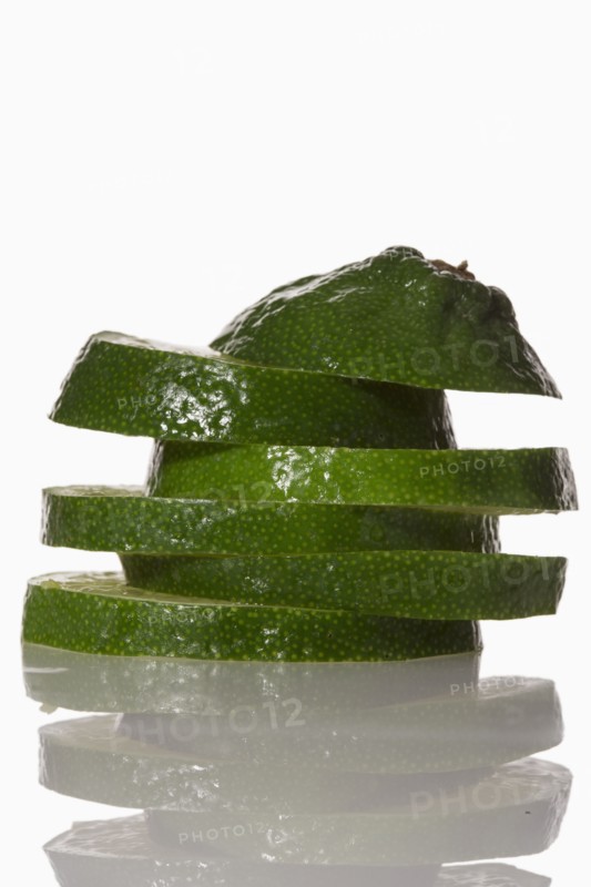 Slices of lime on white background