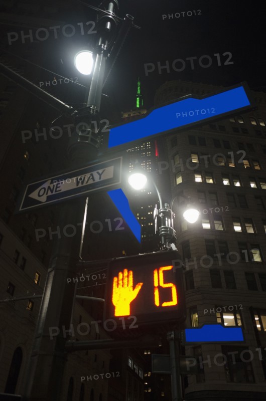 Low-angle view of directional signs in city