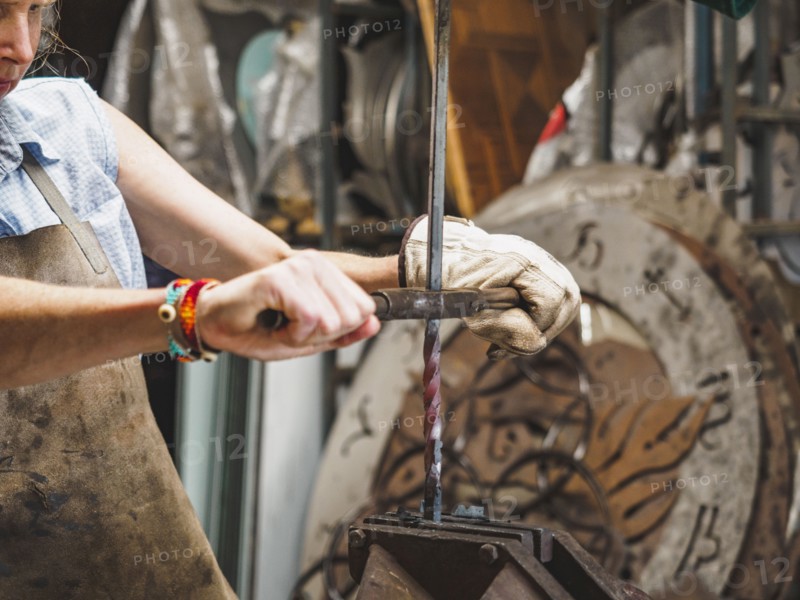 Female blacksmith working in workshop