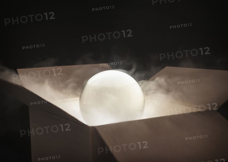 Crystal ball in cardboard box.