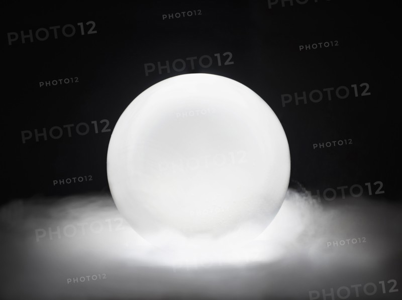 Glowing crystal ball in smoke.