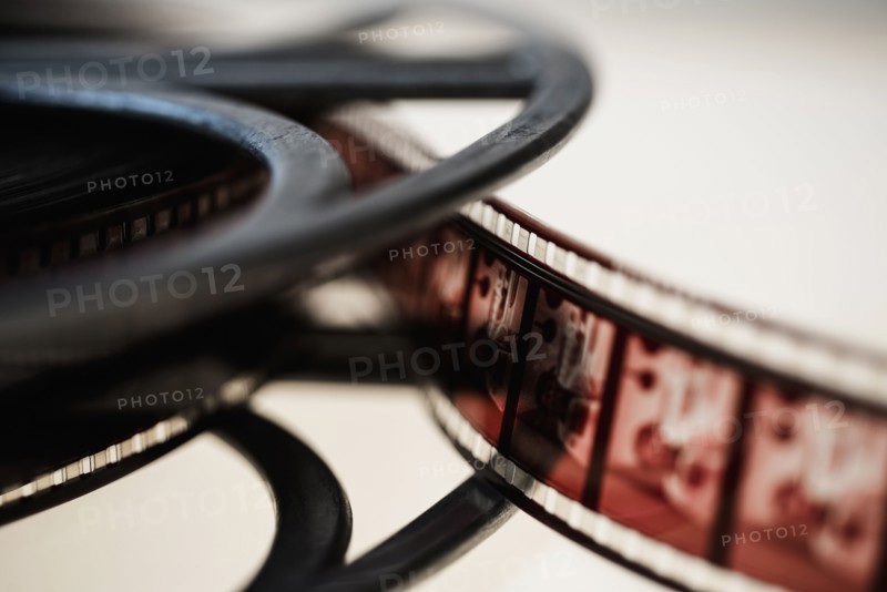 Close-up of film reel on white background.