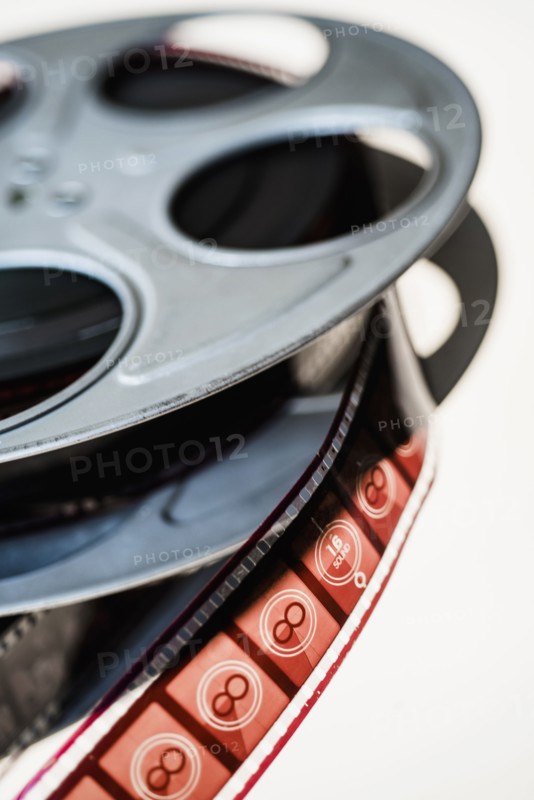 Close-up of film reel on white background.