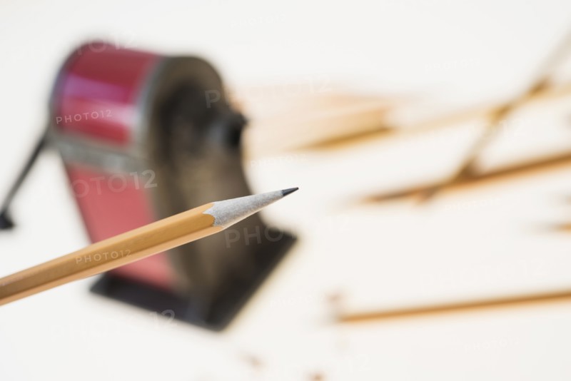 Pencil and antique pink pencil sharpener.