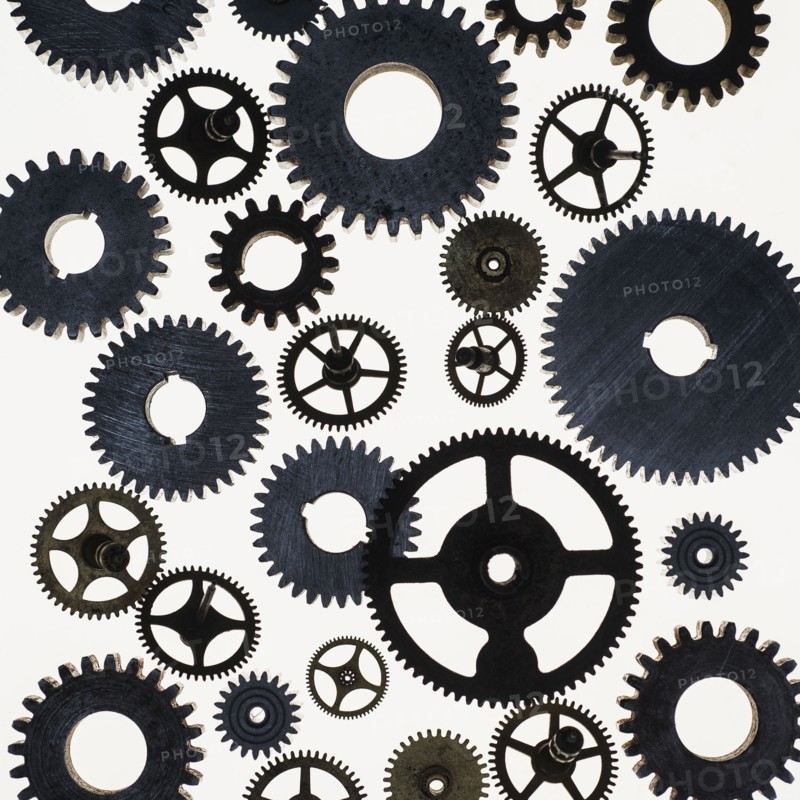 Group of metal gears on white background.