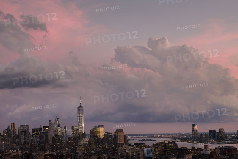 City skyline under dramatic pink sky.