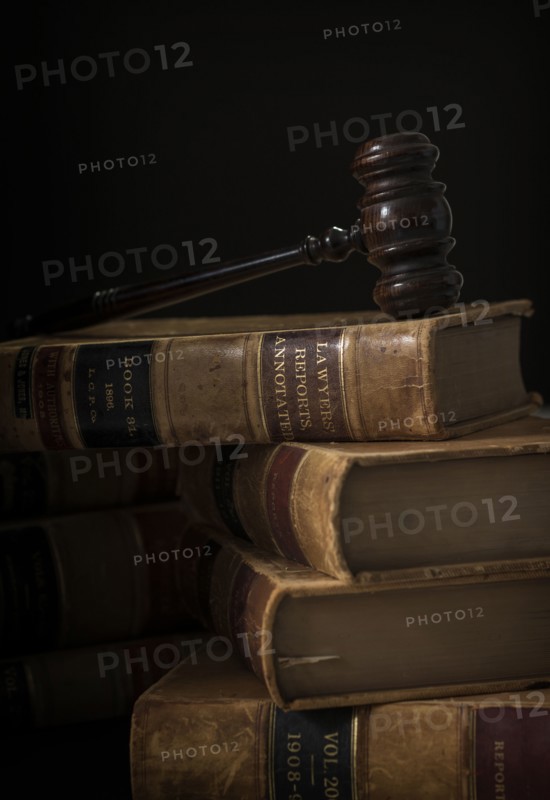 Wooden hammer on stack of books.
