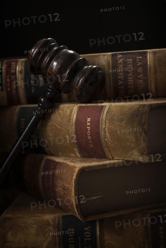 Wooden hammer and stack of books.