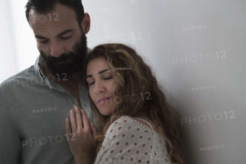 Mid-adult couple hugging.