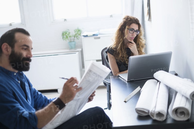 Man and woman working together in office.