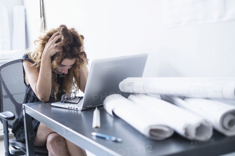 Upset woman in office.