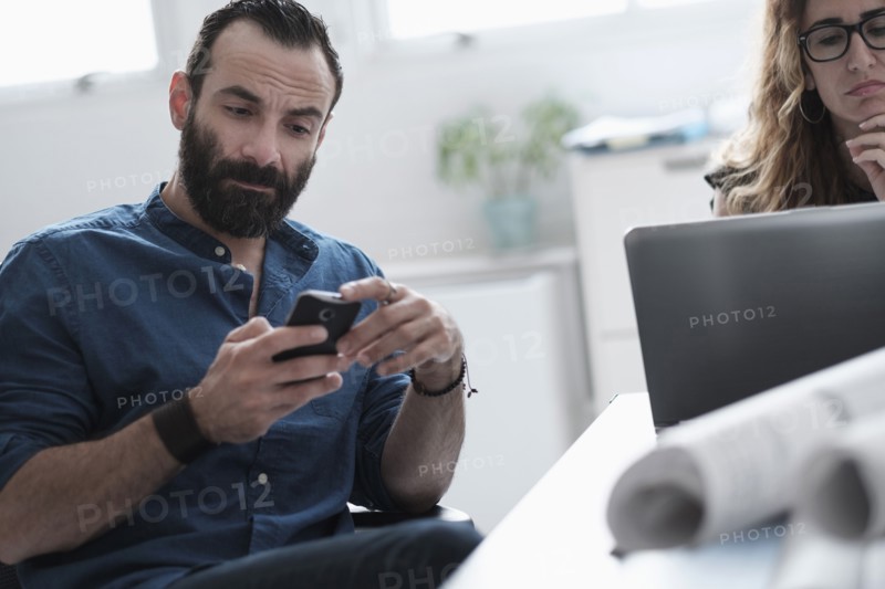 Man and woman working in office.