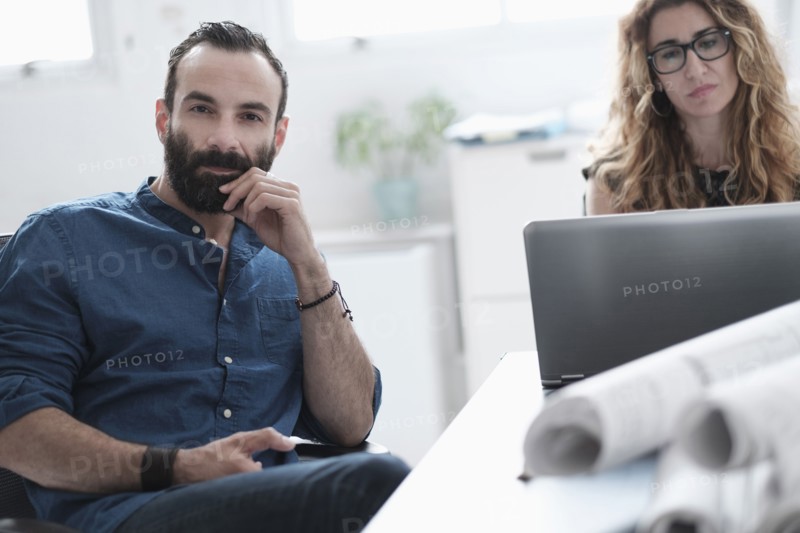 Man and woman talking in office.