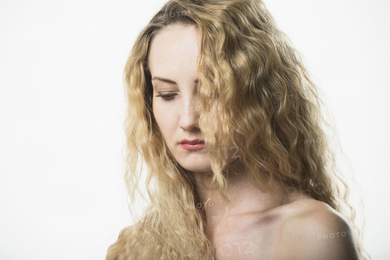 Portrait of beautiful woman with long, blond, curly hair.