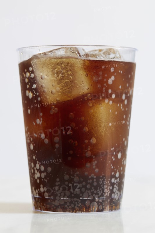 Studio shot of cold drink with ice cubes on white background