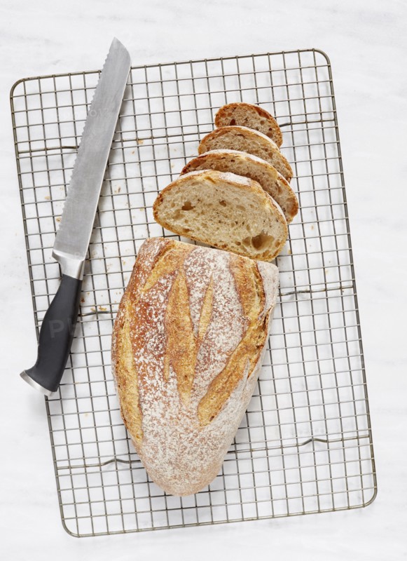 Overhead view of loaf of rye bread and knife