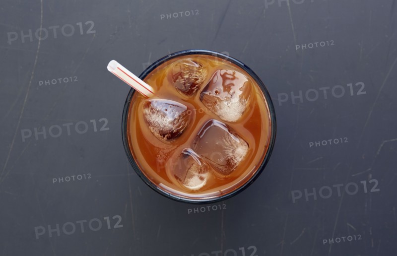 Overhead view of iced coffee with drinking straw