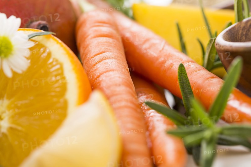 Slice of orange with carrots and fresh herbs