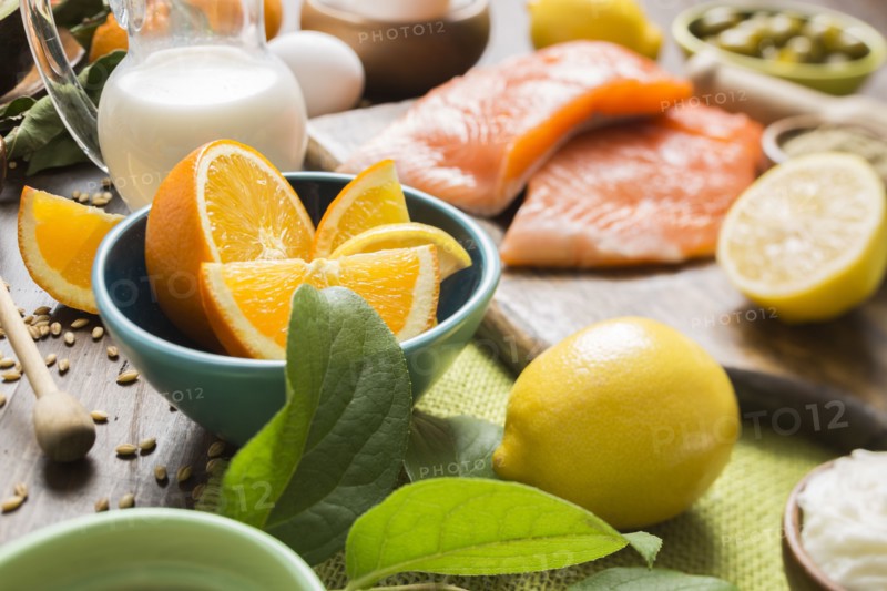 Slices of orange in bowl and salmon fillet