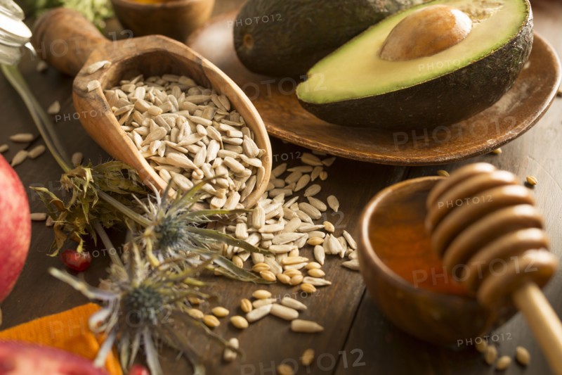 Wheat seeds, avocado and honey with dipper
