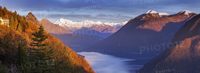 Switzerland, Lugano, Horizontal panorama of mountains and lake at sunset