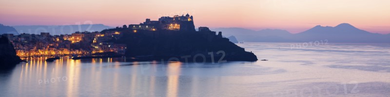 Italy, Campania, Panorama of Procida Island with Mt Vesuvius at sunrise