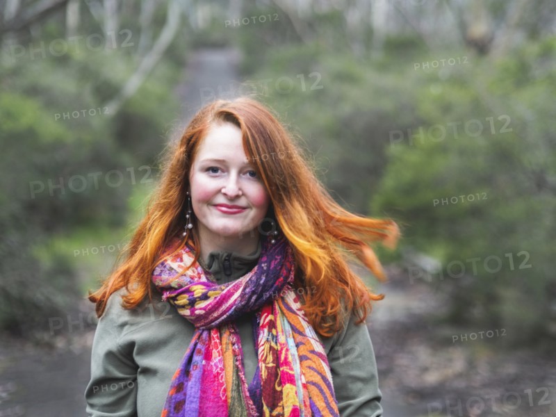 Portrait of smiling redhead woman in scarf