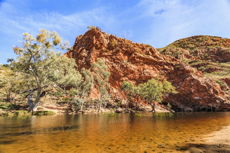 Australia, Outback, Northern Territory, Red Centre, West Macdonnel Ranges, Ormiston Gorge, Orange colored lake in red rock mountains