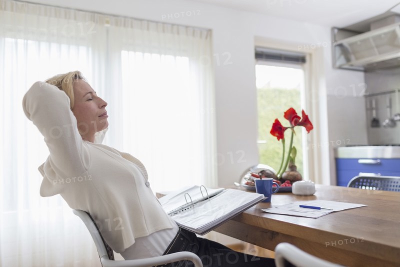 Woman taking break from paperwork