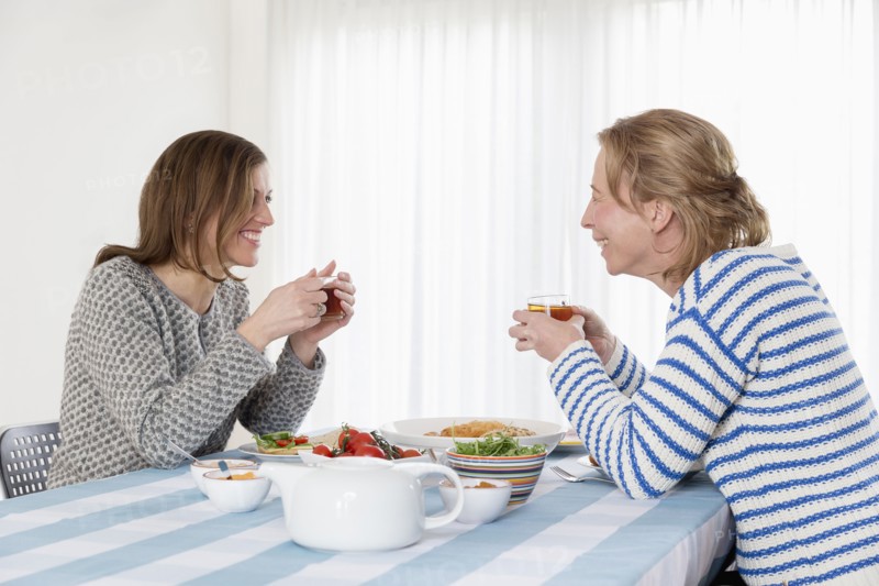 Women at laid table in dining room