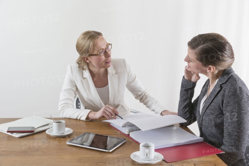 Businesswomen analyzing documents at office