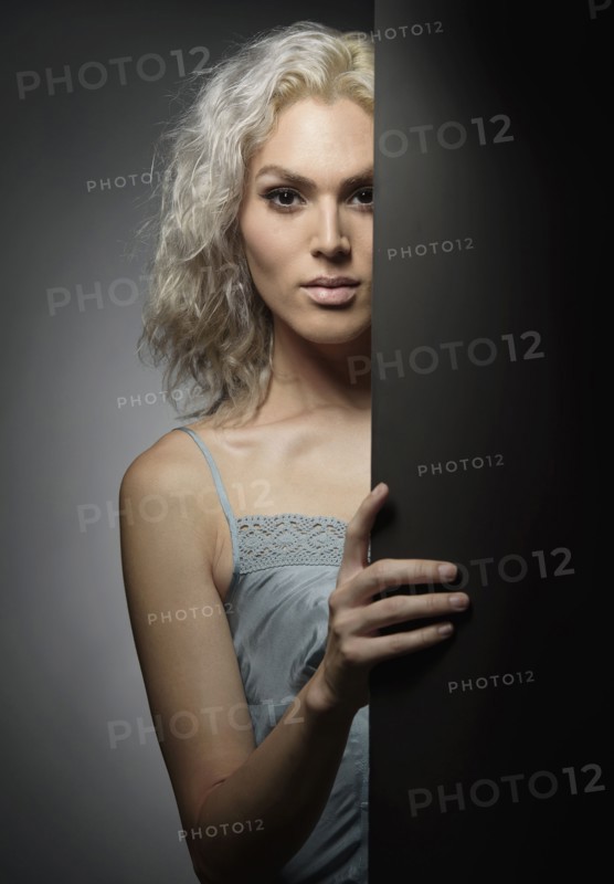Studio portrait of young woman with white hair.