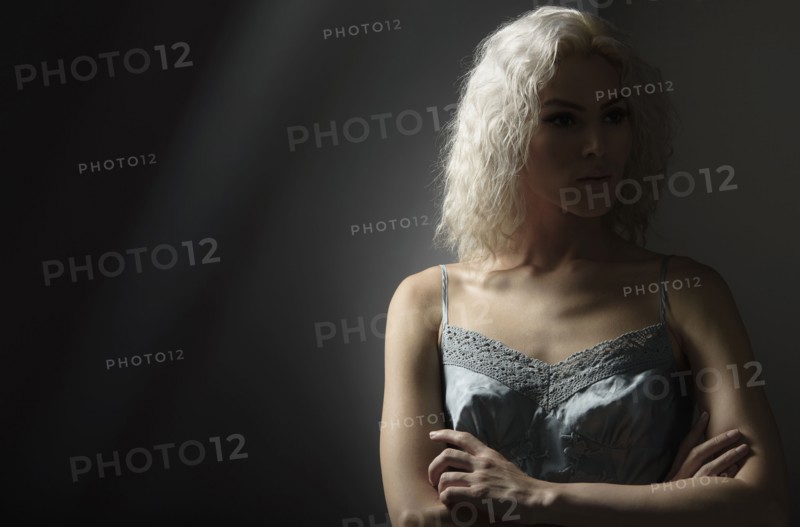 Studio portrait of young woman with white hair.