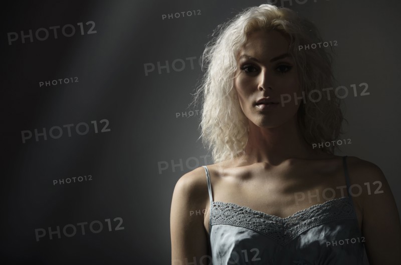 Studio portrait of young woman with white hair.