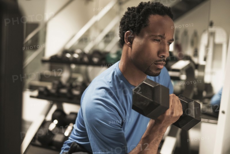 Mid adult man working out in gym.