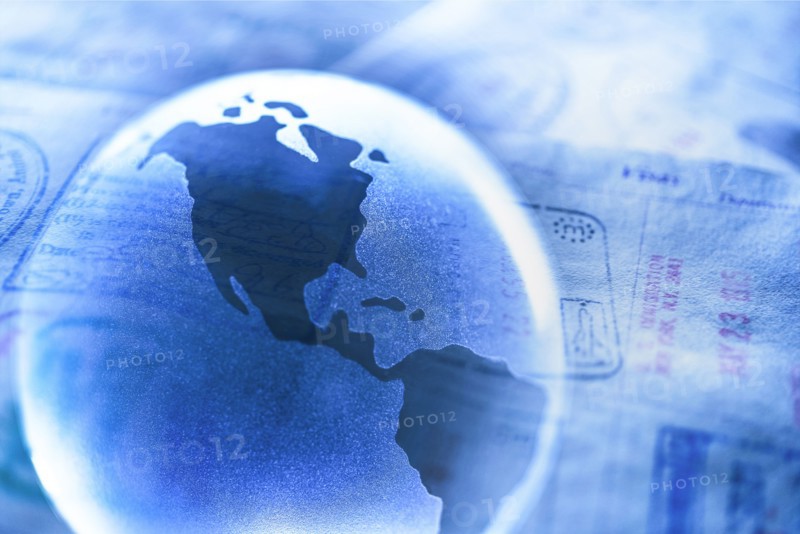 Stamps in passport and Planet Earth.