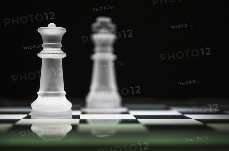 Chess queen and king on chess board.