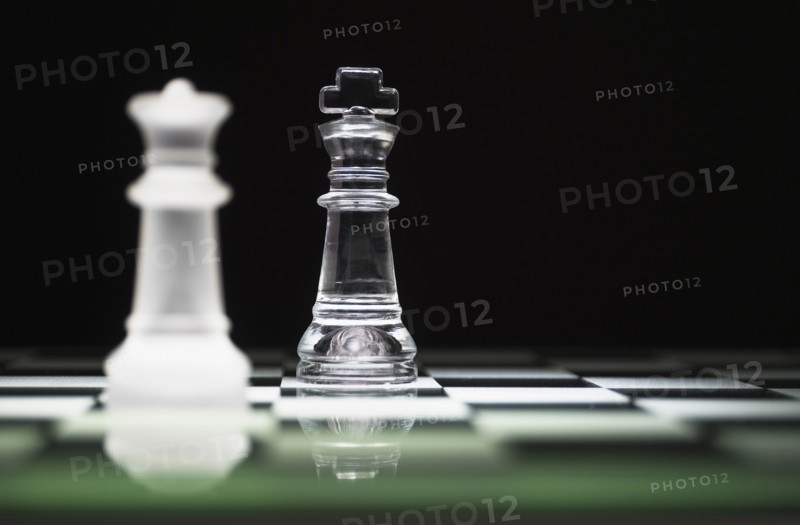 Chess queen and king on chess board.