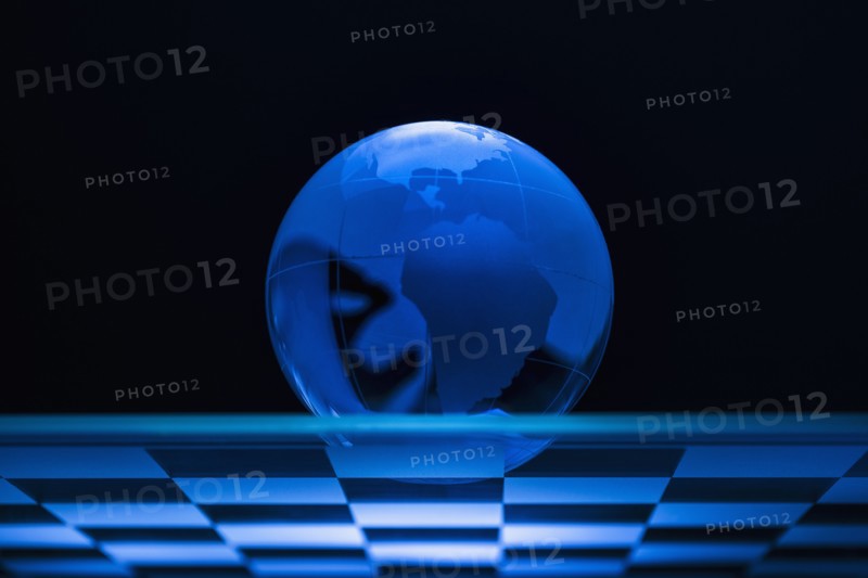 Globe on chess board.